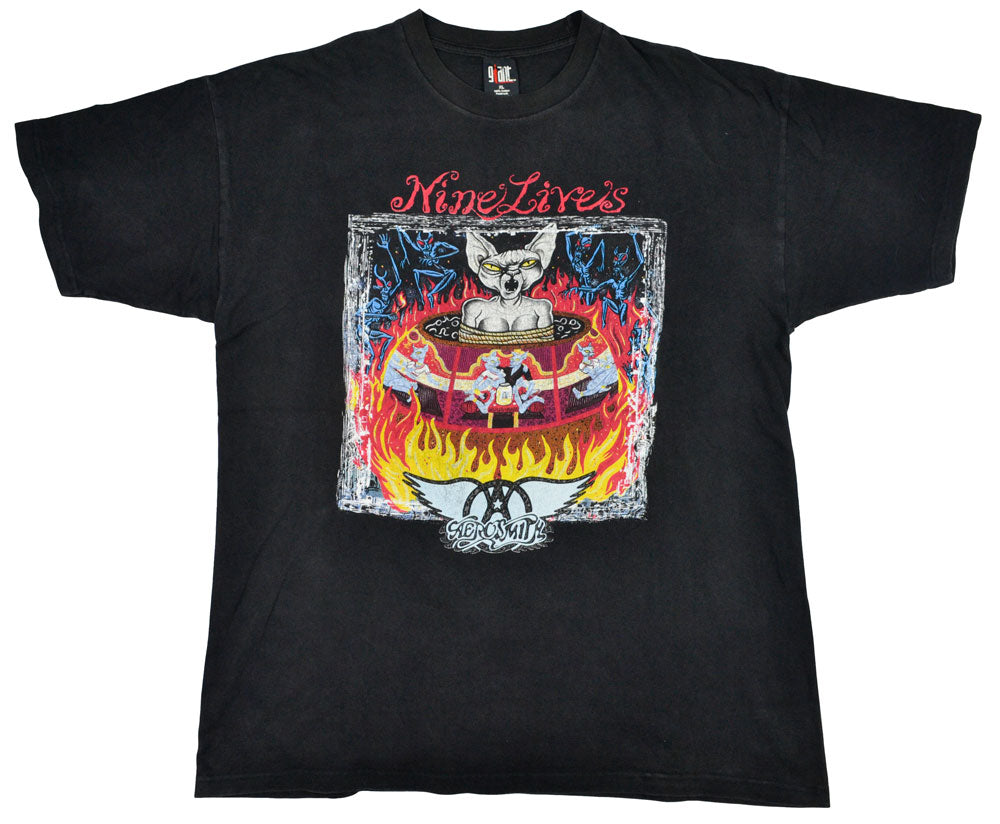 Vintage Aerosmith 1997 "Nine Lives" Tour Shirt  "I Don´t Want to Miss a Thing". Aerosmith is one of the best-selling bands of all time. They have been included into the Rock Hall of Fame in 2001, and in 2005 they were ranked No. 57 on the Rolling Stones list of 100 Greatest Artists of All Time. The tee has a great fade and incredible graphic.