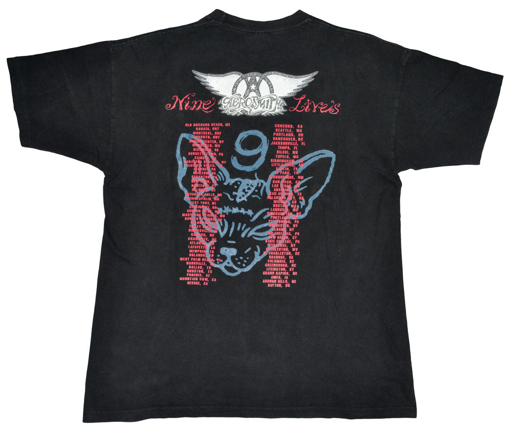 Vintage Aerosmith 1997 "Nine Lives" Tour Shirt  "I Don´t Want to Miss a Thing". Aerosmith is one of the best-selling bands of all time. They have been included into the Rock Hall of Fame in 2001, and in 2005 they were ranked No. 57 on the Rolling Stones list of 100 Greatest Artists of All Time. The tee has a great fade and incredible graphic.