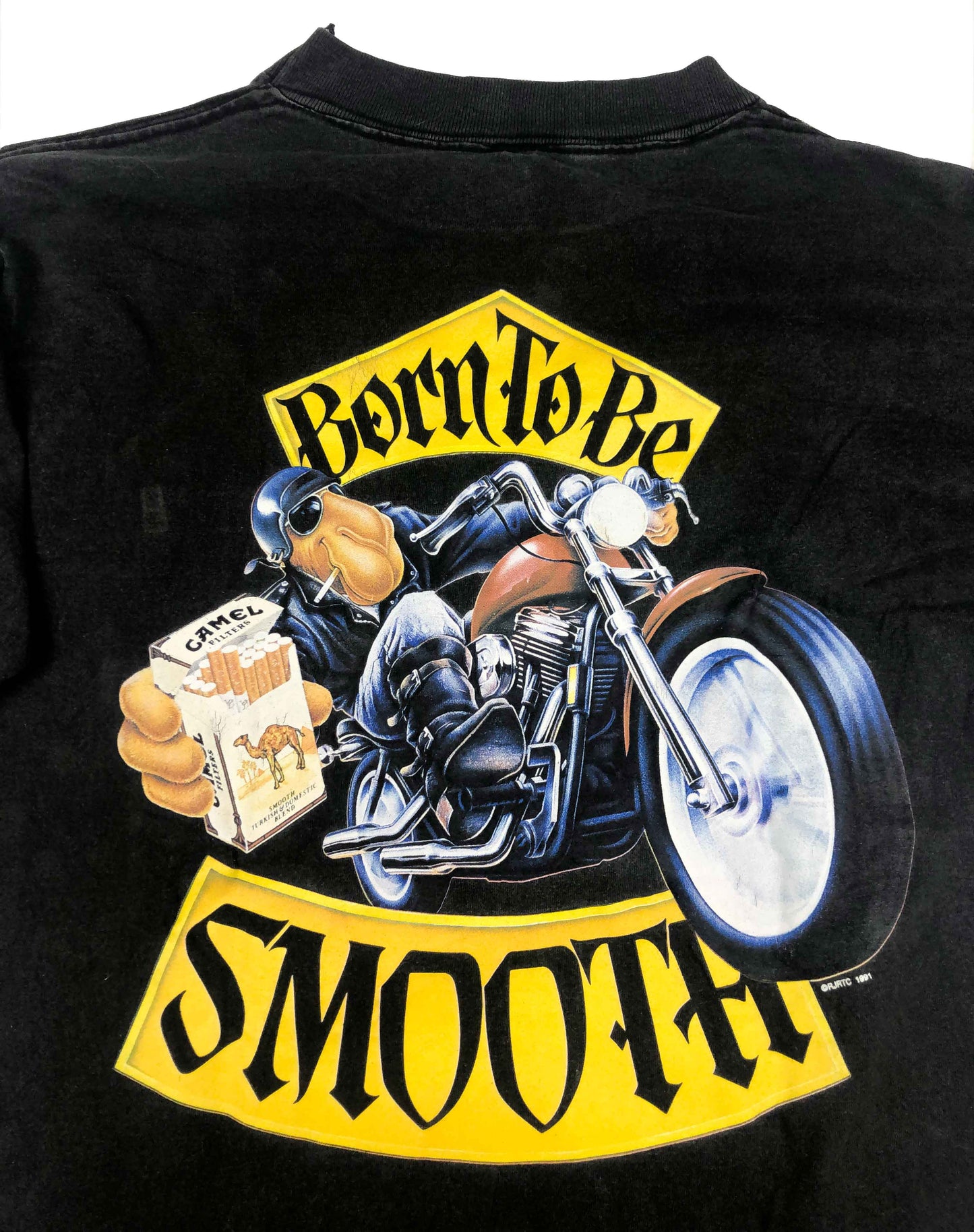 Vintage Promotional T-Shirt 1991 Camel Cigarettes "Born To Be Smooth" This is a vintage promotional shirt from the American brand of cigarettes Camel. The long sleeve presents a really good fade and vintage look.