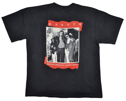 Vintage Dakota Cigarettes 1991 Promotional Shirt Dakota Cigarettes was a brand of American tobacco which was introduced in 1990. After test-marketing in several American cities, the brand didn't yield the desired results and was eventually withdrawn in the same year of its released. The tee has a crazy back graphic and a really good fade and vintage look.