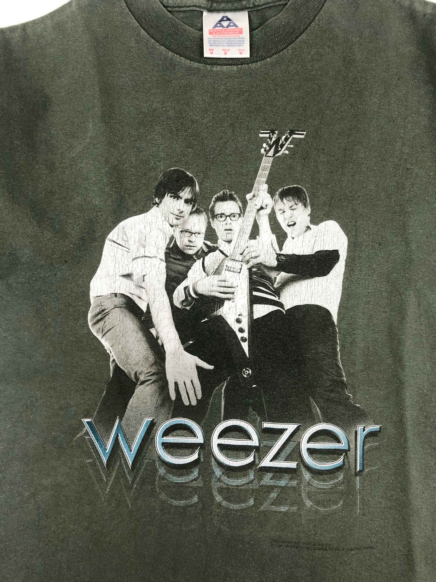 Vintage Band T-Shirt 2002 Weezer "Hyper-Extended Midget" Tour The Hyper-Extended Midget Tour supported the third studio album from the band, Green Album. With a more pop sound, the album was a commercial success and received mostly positive reviews by the fans. It debuted at number four in the United States and the song Hash Pipe was a worldwide hit, charting on seven different charts. The tee has a really good vintage look.