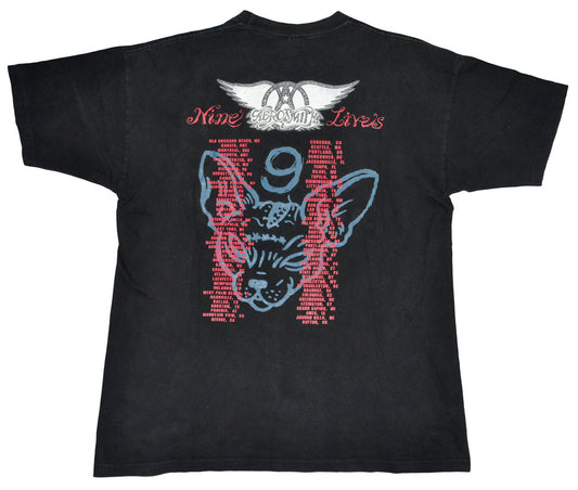 Vintage Aerosmith 1997 "Nine Lives" Tour Shirt  "I Don´t Want to Miss a Thing". Aerosmith is one of the best-selling bands of all time. They have been included into the Rock Hall of Fame in 2001, and in 2005 they were ranked No. 57 on the Rolling Stones list of 100 Greatest Artists of All Time. The tee has a great fade and incredible graphic.