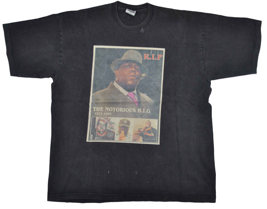 Vintage Biggie 00s "Memorial" Rap Shirt Christopher Wallace, Biggie Smalls or Notorious B.I.G. began experimenting with music in his teens, where he began to forge his close friendship with Sean "Puffy" Combs. His 1994 debut album, Ready to Die, was a huge success. Rolling Stones Magazine ranked the album at No. 23 of the 100 greatest debut albums of all time. Biggie was killed in Los Angeles on March 9, 1997. The tee has a crazy vintage look.